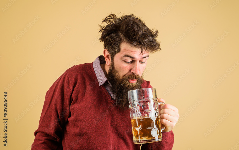Leisure and beer time. Drunk bearded man tasting fresh brewed beer. Oktoberfest festival. Brewer with glass of craft beer. Germany traditions. Alcohol. Handsome male drinking draft beer in bar or pub. Leisure and beer time. Drunk bearded man tasting fresh brewed beer. Oktoberfest festival. Brewer with glass of craft beer. Germany traditions. Alcohol. Handsome male drinking draft beer in bar or pub.