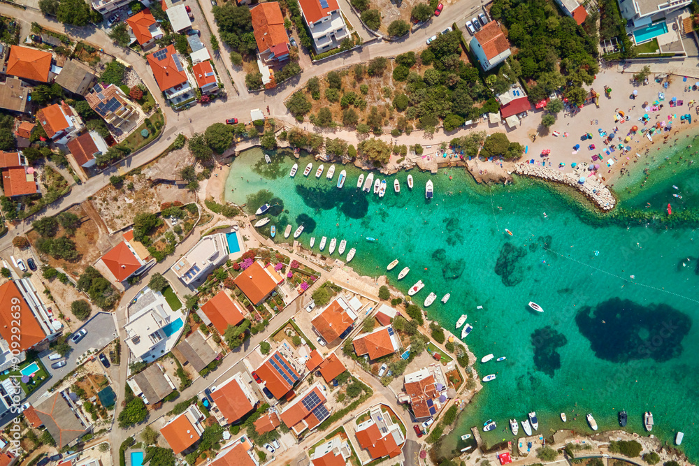 Aerial top view of coastal village with red-roofed houses, turquoise waters and boats along shore. Panorama of tourist town Rogoznica in Croatia on Adriatic Sea. Summer vacation concept Aerial top view of coastal village with red-roofed houses, turquoise waters and boats along shore. Panorama of tourist town Rogoznica in Croatia on Adriatic Sea. Summer vacation concept