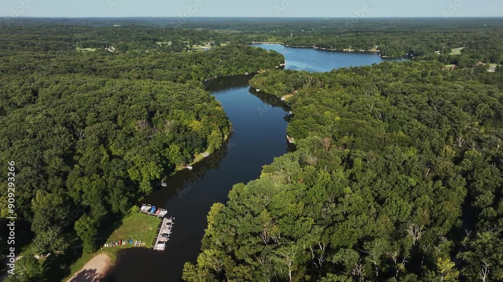 Aerial view of connecting lakes with boats and green trees on a beautiful sunny summer day. Aerial view of connecting lakes with boats and green trees on a beautiful sunny summer day.