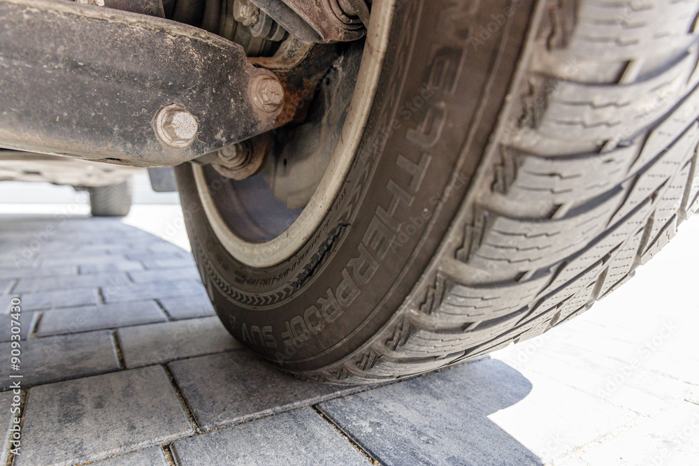 Damaged car tire on alloy rim, long crack on the inside Damaged car tire on alloy rim, long crack on the inside