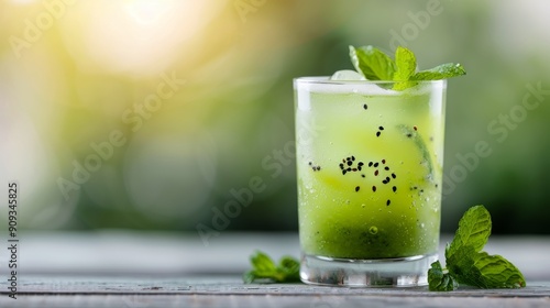 Refreshing Green Smoothie on Vibrant Green Leaves With Raindrops