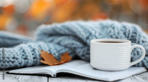 Cozy Autumn Moment With Hot Beverage, Knitted Blanket, and Leaves on a Table