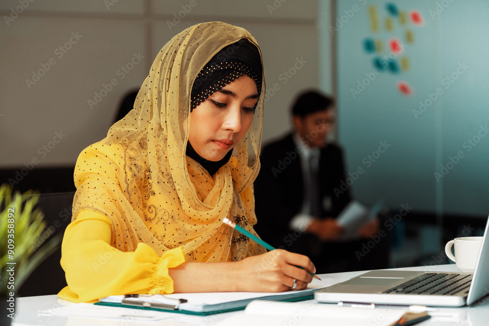 Successful Middle Eastern Muslim businesswoman working in office. International business success concept. uds Successful Middle Eastern Muslim businesswoman working in office. International business success concept. uds