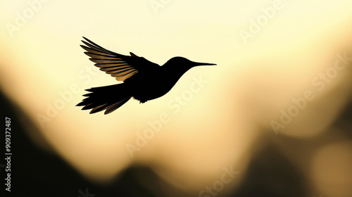 Silhouette of Bird in Flight Against Yellow Sunset Background for Nature-Themed Designs, Wildlife Photography, and Peaceful Scenery Concepts photo