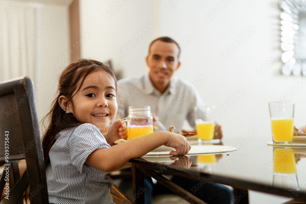 Potrait of little girl sitting at table eating a lunch. Potrait of little girl sitting at table eating a lunch.