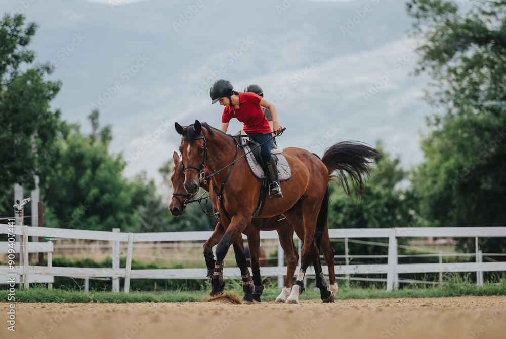 Young girl riding a horse during a training session at an outdoor equestrian facility with scenic mountain and tree background. Young girl riding a horse during a training session at an outdoor equestrian facility with scenic mountain and tree background.