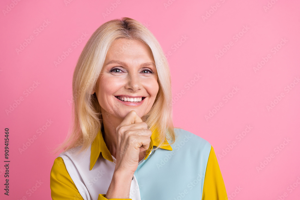 Photo of elegant aged lady hand chin think wear shirt isolated on pink color background Photo of elegant aged lady hand chin think wear shirt isolated on pink color background