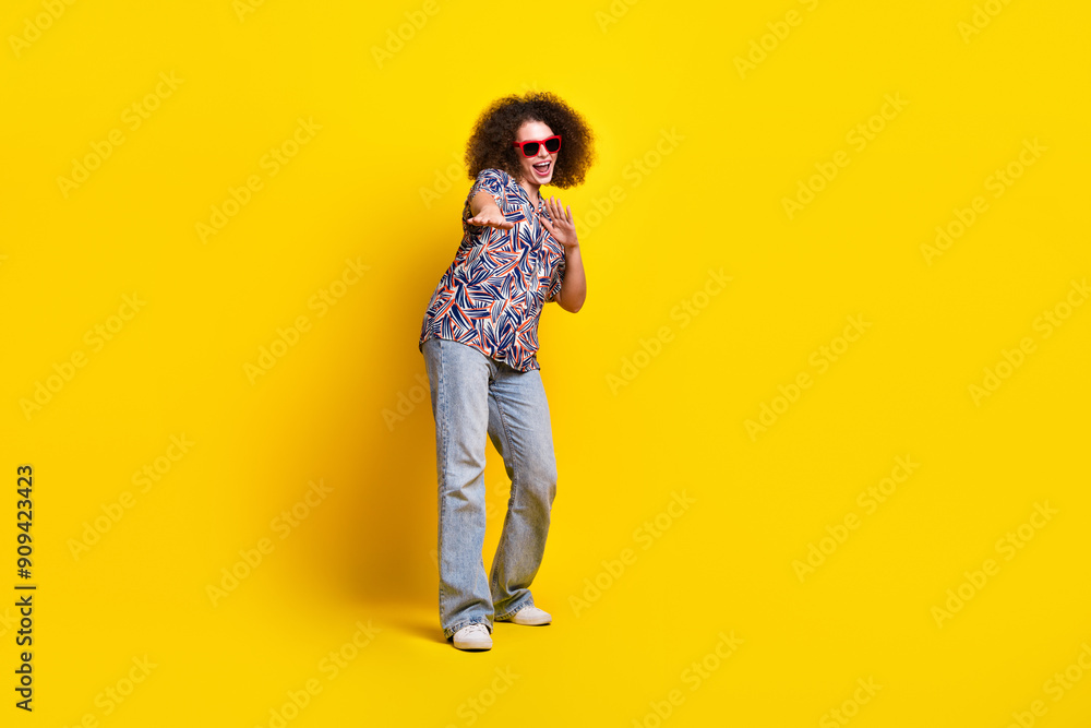 Fototapeta premium Full body photo of attractive young woman sunglass dancing dressed stylish colorful clothes isolated on yellow color background