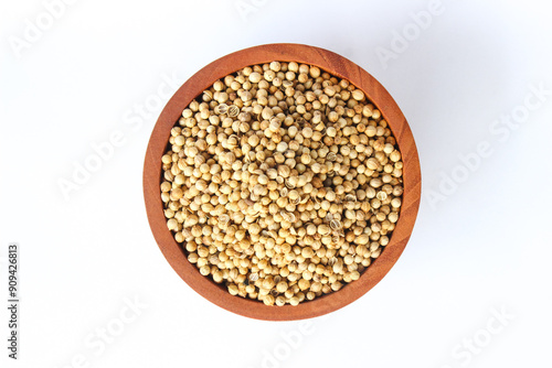 White pepper seeds or Peppercorns in a wooden bowl isolated on white background. Top view. Flat lay 