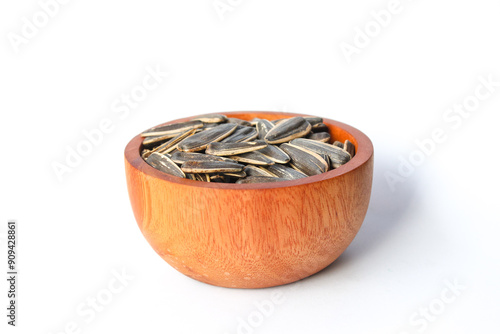 Kwaci or Sunflower Seeds, snack made from dried and salted sunflower seeds in a wooden bowl isolated on white background photo