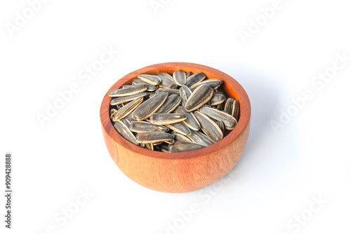 Kwaci or Sunflower Seeds, snack made from dried and salted sunflower seeds in a wooden bowl isolated on white background photo