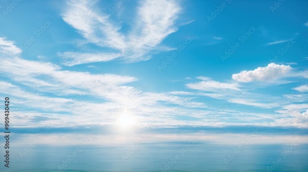 Expansive navy sea beneath a sky with light clouds and sunny rays Expansive navy sea beneath a sky with light clouds and sunny rays