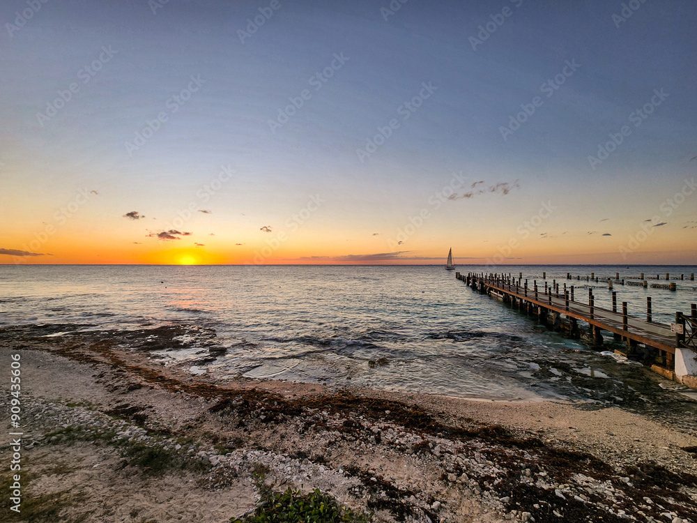 Fototapeta premium Sailboat, Pier, and Sunset on Cozumel Beach