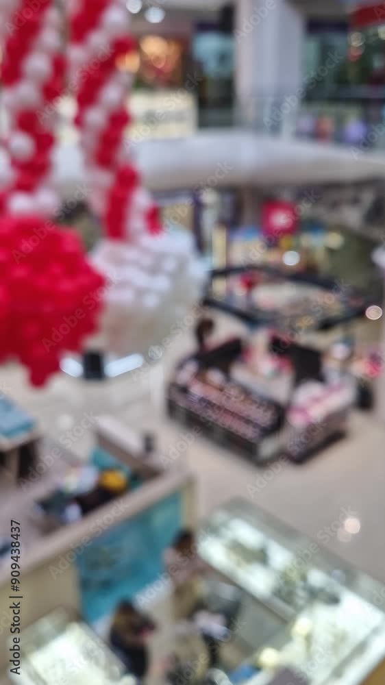 Defocused scene of people shopping inside a modern mall. Blurred background of commercial center indoors view Defocused scene of people shopping inside a modern mall. Blurred background of commercial center indoors view