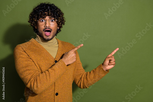 Photo portrait of pretty young male point shocked empty space wear trendy brown outfit isolated on khaki color background photo