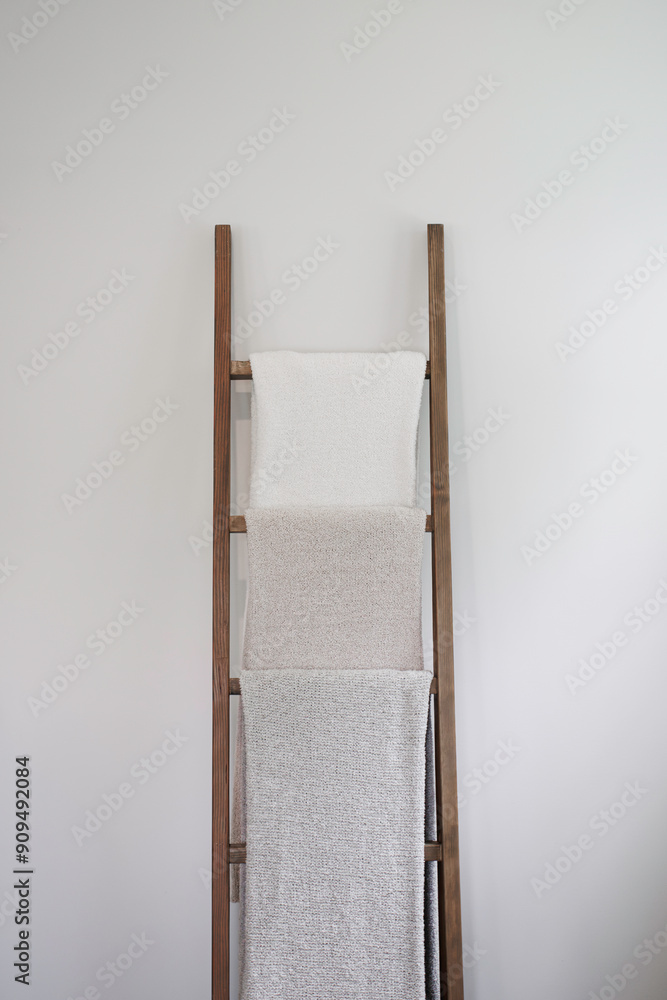Wooden Ladder With Three Towels Against White Wall For Storage And Decor Wooden Ladder With Three Towels Against White Wall For Storage And Decor