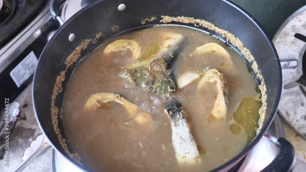 Cooking fish curry, gulai or pindang ikan patin. Cooking fish curry, gulai or pindang ikan patin.
