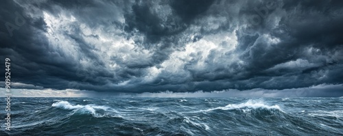 Stormy ocean waves under dark dramatic clouds, panoramic seascape. Nature power and weather concept