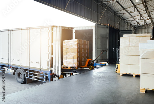 Bulk pallets of packaging boxes being loaded onto a container truck. distribution warehouse Container transport, supply chain, parcel delivery. Freight truck, logistics, transportation. photo