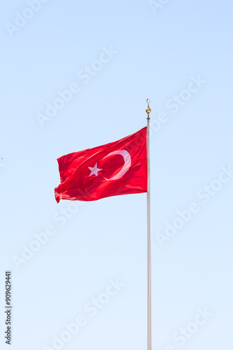 Turkish flag waving in the blue sky. The Turkish flag is raised. 