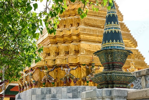 Panom mak sculpture and Phra Suvarnachedi, a golden square-based chedi (stupa) supported by monkey and yaksha (mythological giants) from the Ramakien at Wat Phra Kaew (Temple of the Emerald Buddha) photo