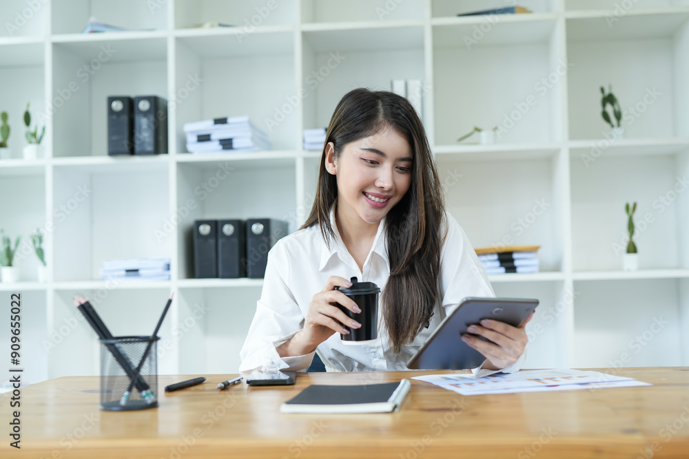 Asian business woman Use a laptop computer and work at the office ready. plan to analyze financial reports
Asian business woman Use a laptop computer and work at the office ready. plan to analyze financial reports