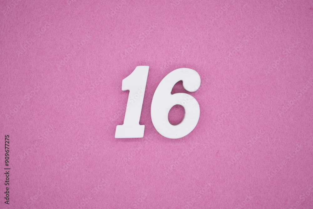 The numbers are made of white painted wood. Laying on the floor was pink paper. The numbers are made of white painted wood. Laying on the floor was pink paper.