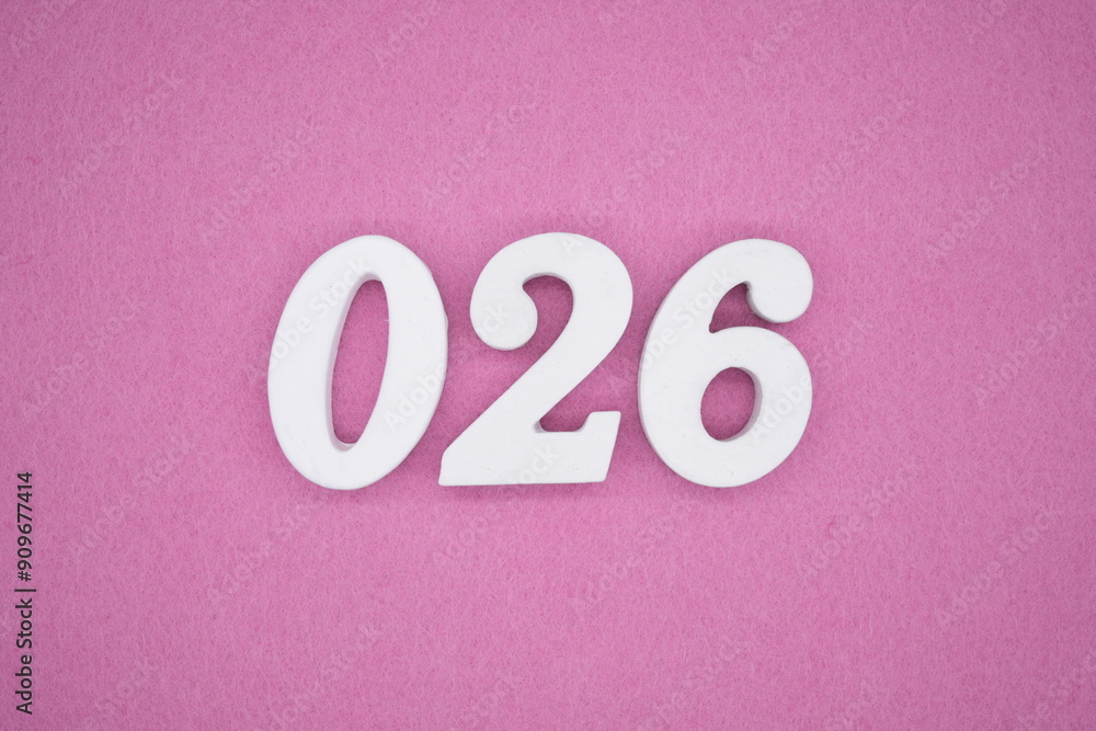 The numbers are made of white painted wood. Laying on the floor was pink paper. The numbers are made of white painted wood. Laying on the floor was pink paper.