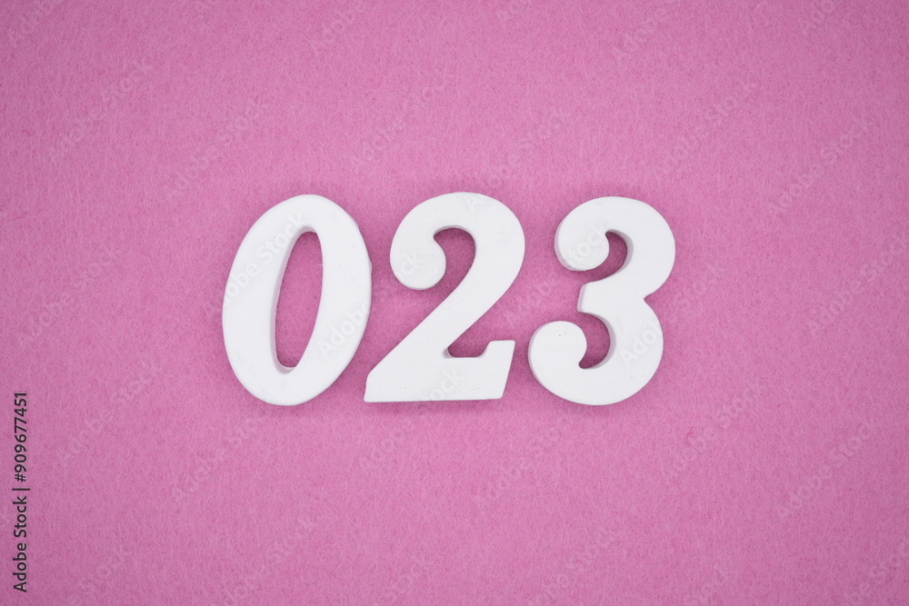 The numbers are made of white painted wood. Laying on the floor was pink paper. The numbers are made of white painted wood. Laying on the floor was pink paper.