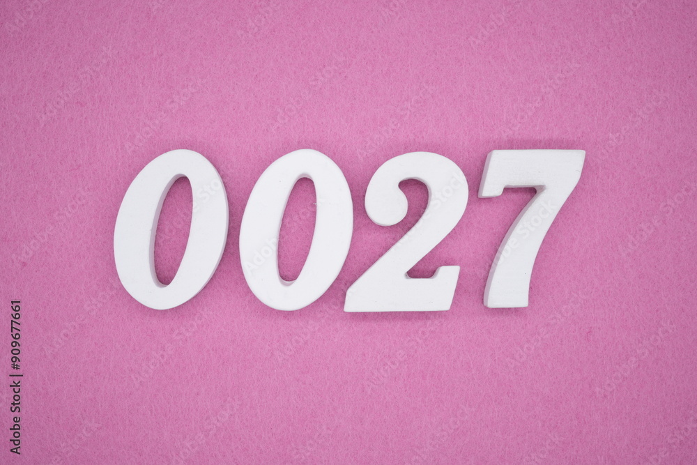 The numbers are made of white painted wood. Laying on the floor was pink paper. The numbers are made of white painted wood. Laying on the floor was pink paper.