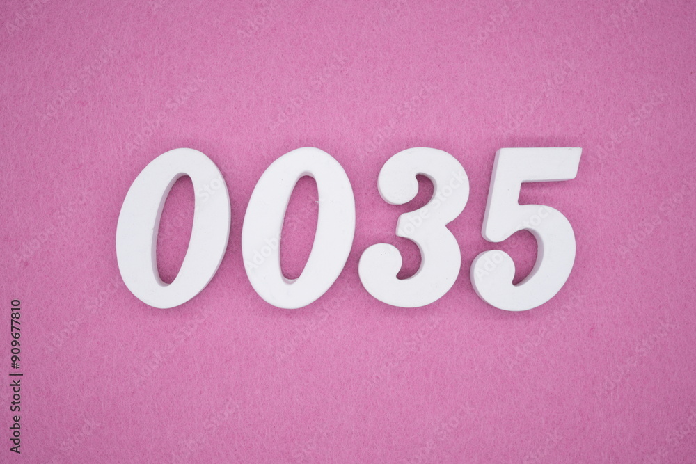 The numbers are made of white painted wood. Laying on the floor was pink paper.