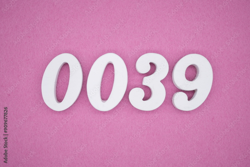 The numbers are made of white painted wood. Laying on the floor was pink paper. The numbers are made of white painted wood. Laying on the floor was pink paper.