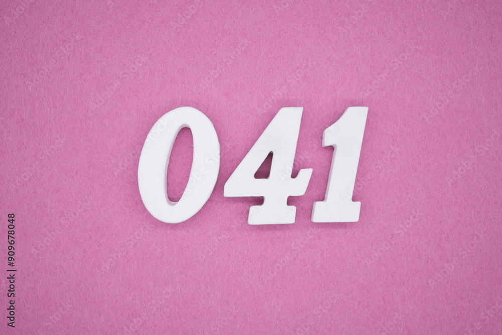 The numbers are made of white painted wood. Laying on the floor was pink paper. The numbers are made of white painted wood. Laying on the floor was pink paper.
