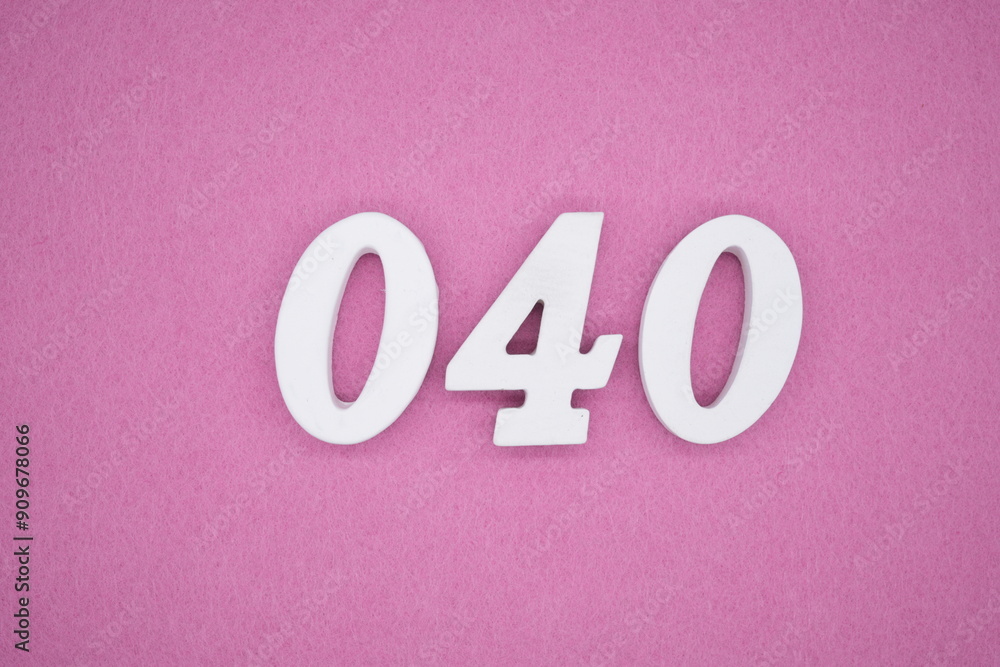 The numbers are made of white painted wood. Laying on the floor was pink paper. The numbers are made of white painted wood. Laying on the floor was pink paper.