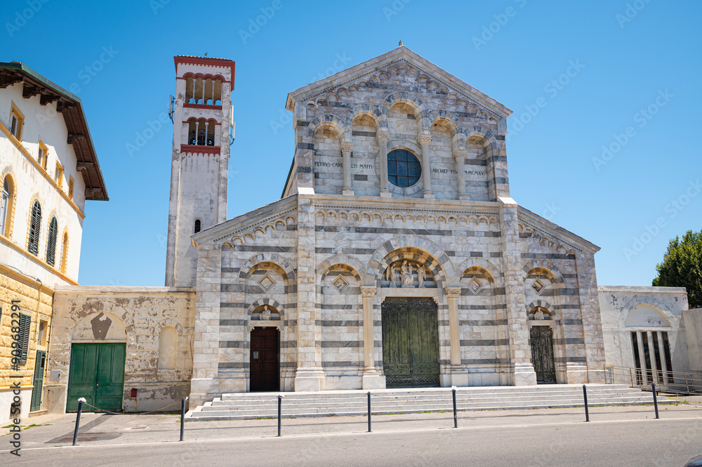 Fototapeta premium Beautiful Catholic church ¨Parrocchia di Santa Maria Ausiliatrice¨ in neo-Romanesque style in the town of Marina di Pisa, Italy