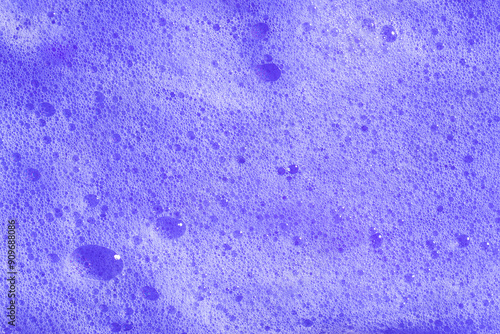 Purple hair shampoo foam. Violet lavender foaming soap closeup. Foam texture background. photo