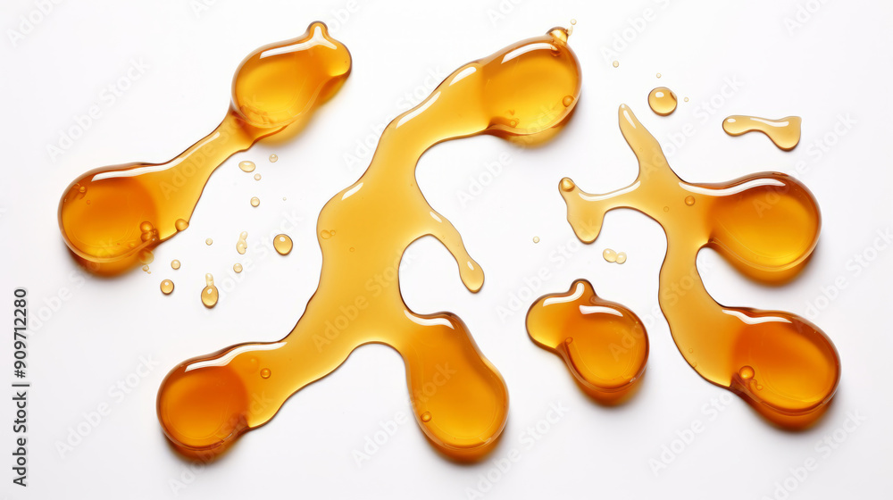 Spilled honey drops isolated on a white background, top view. Spilled honey drops isolated on a white background, top view.