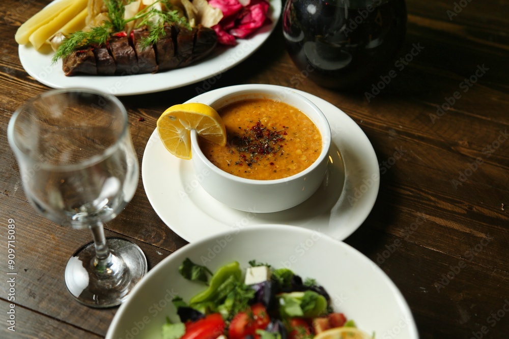 Lentil Soup and Salad on a Wooden Table Lentil Soup and Salad on a Wooden Table