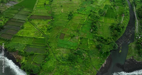 This stunning aerial view showcases a lush green coastal landscape below photo