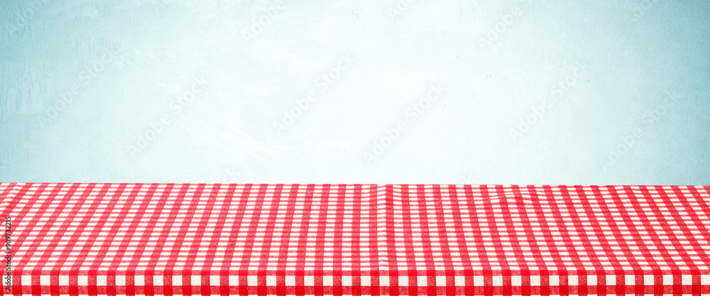 Empty table with red and white check pattern tablecloth over blue wall background, banner, table top, shelf, counter design for product display montage Empty table with red and white check pattern tablecloth over blue wall background, banner, table top, shelf, counter design for product display montage