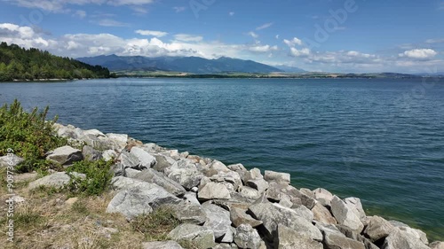 Wallpaper Mural Rocky lakeshore with clear blue water and distant mountains Torontodigital.ca