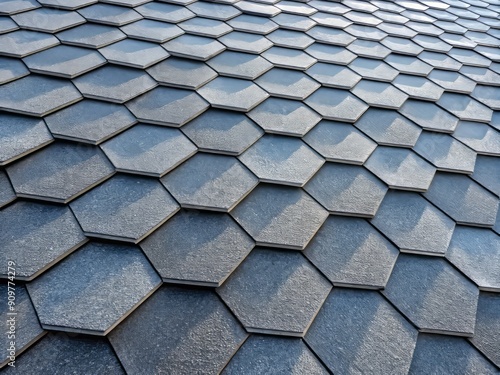 Hexagonal slate shingles in a modern roofing pattern, featuring a textured, flexible bitumen surface, perfect for chimneys, adding a touch of elegance to any building's exterior.