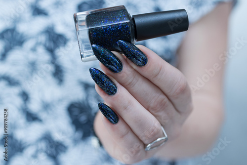 Woman's hand with long nails black and dark blue manicure photo