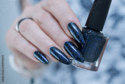 Woman's hand with long nails black and dark blue manicure photo