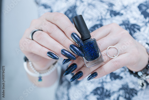 Woman's hand with long nails black and dark blue manicure photo