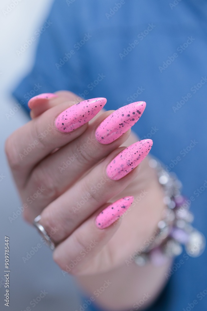 Female hands with long nails and neon light pink nail polish Female hands with long nails and neon light pink nail polish