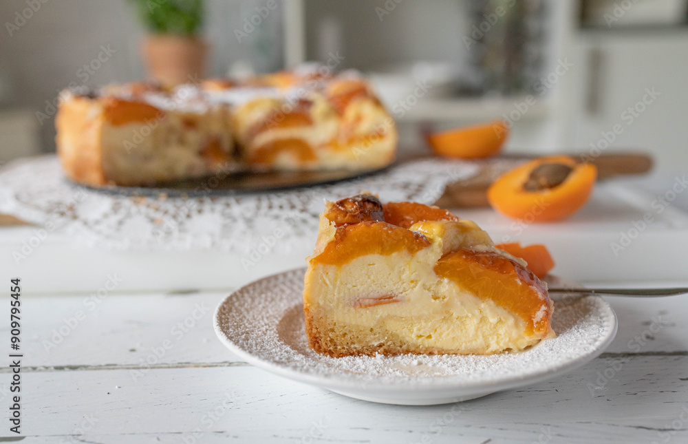 Piece of delicious homemade apricot cheesecake on a white table. Piece of delicious homemade apricot cheesecake on a white table.