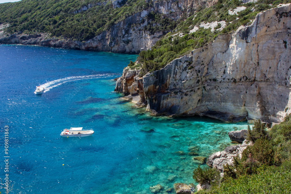 Boats on Crystal Clear Waters Along Rocky Coastline in Greece