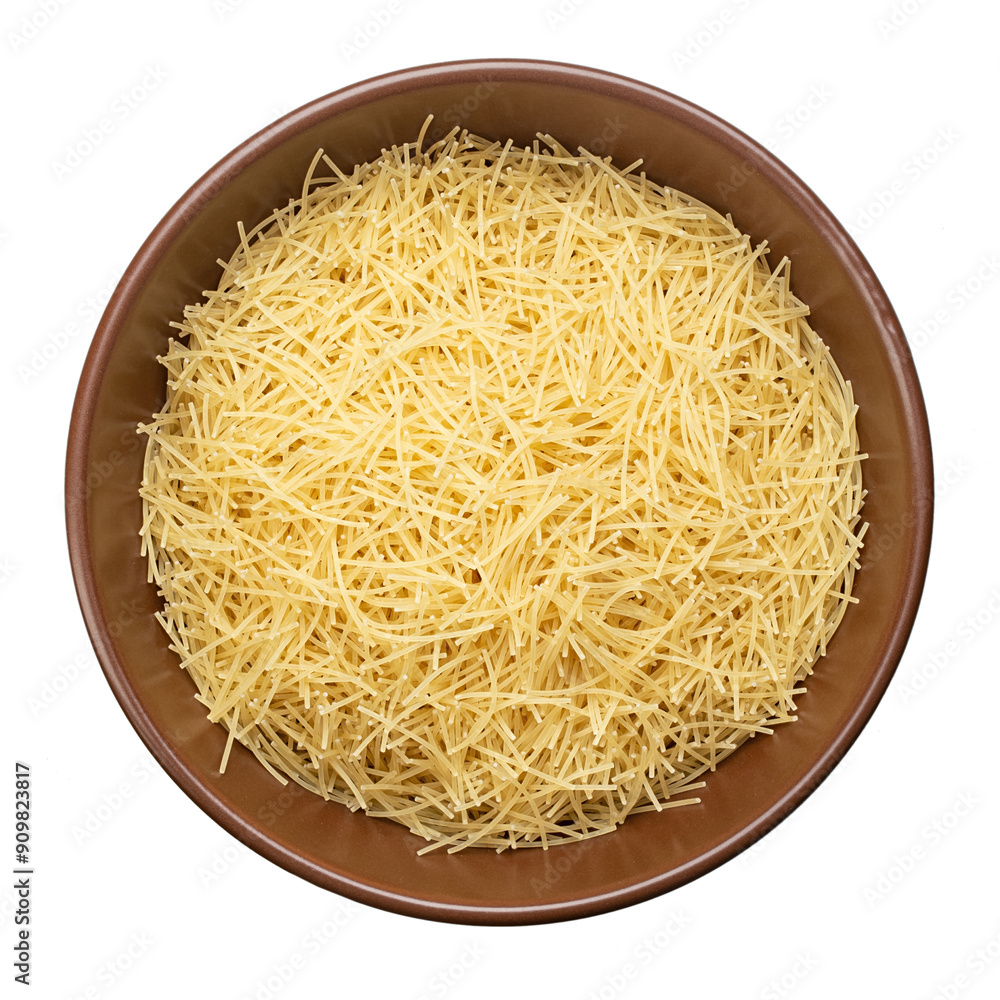Filini raw pasta in clay bowl isolated on white background. File contains clipping path. Traditional Italian pasta. Filini raw pasta in clay bowl isolated on white background. File contains clipping path. Traditional Italian pasta.
