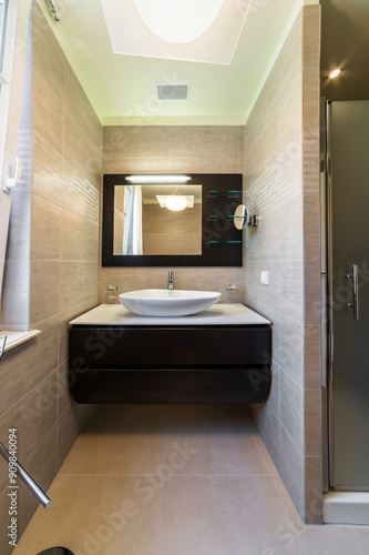 Wallpaper Mural Modern bathroom interior design featuring beige-colored tiled floor and walls. Sink is mounted on dark brown wooden cabinet, adding contrast. Above the sink, mirror is mounted on dark brown panel Torontodigital.ca